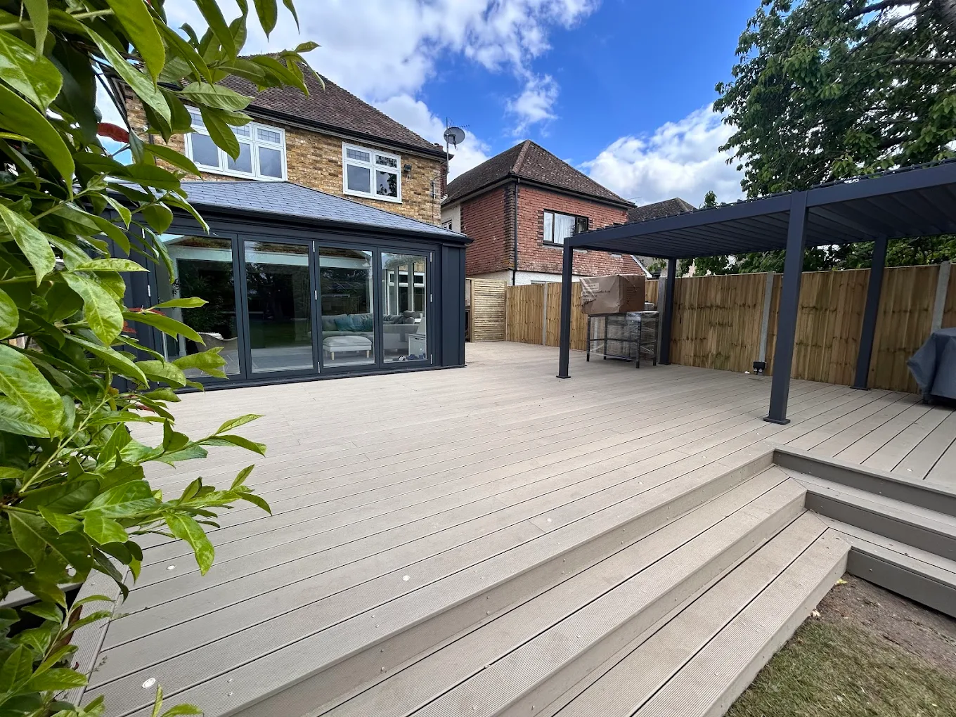 Premium landscaped garden with expansive deck and covered outdoor structure