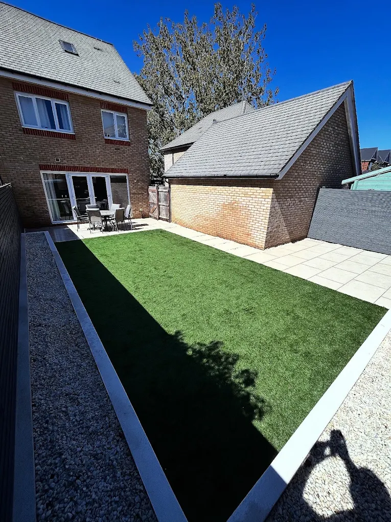 Compact garden redesign with crisp edging and artificial lawn